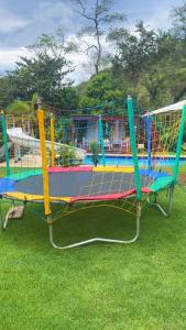 a brightly colored play equipment in the grass at Sítio recanto do Saltinho Santa teresa -ES in Santa Teresa