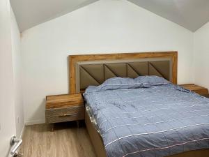 a bedroom with a bed with a blue comforter at Modern Penthouse with Unbeatable Panoramic Views in Peje