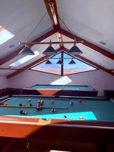 a room with a pool table and some lights at Hotel Bran Dracula in Bran