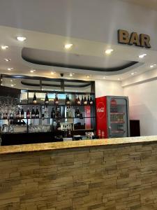 a bar in a restaurant with a coca cola machine at Hotel Bran Dracula in Bran