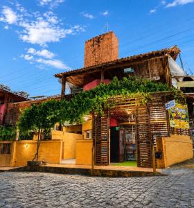 a building with vines on the front of it at Pousada dos Pássaros Pipa in Pipa