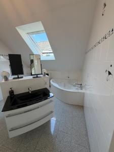 a bathroom with a sink and a tub and a mirror at Burgblick in Bernkastel-Kues +10 photos