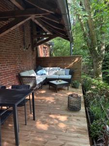 a patio with a couch and a table at Kutscherhaus in Uelzen
