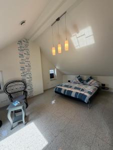 a bedroom with a bed and a chair in a attic at Burgblick in Bernkastel-Kues