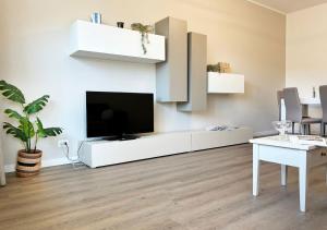 a living room with a tv on a white wall at Holihome - LUNA in Tortoreto Lido