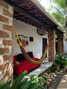 a hammock on the porch of a house at Residencial dos Freitas in Jericoacoara