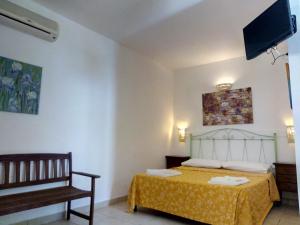 a bedroom with a bed and a chair at Villa Mediterranea in Torre dell'Orso