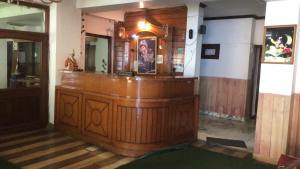 a large wooden bar in a room with at Tara Regency Hotel in Shimla