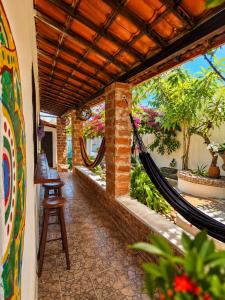a porch with a hammock in a house at Residencial dos Freitas in Jericoacoara