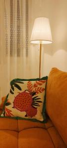 a lamp sitting next to a bed with a pillow at Victor spa Apartment in Veliko Gradište +2 photos