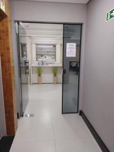 an open door to a kitchen in a building at Tulipa Hotel in Foz do Iguaçu +83 photos