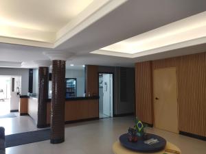 a lobby with columns and a door in a building at Tulipa Hotel in Foz do Iguaçu