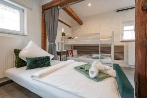 two twin beds in a room with two windows at A9 City Boardinghouse ,WiFi , Parking, VAT Invoice in Günzburg