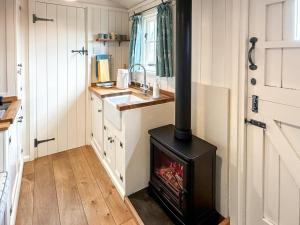 a small stove in a kitchen with a sink at 1 Bed in Stockport oc-87592 in Mellor
