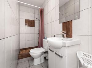 a white bathroom with a toilet and a sink at Martina in Stegna +27 photos