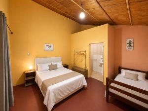 a bedroom with a large bed and a bathroom at Stress Zero in Lopes