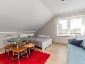 a room with a table and chairs and a bed at Martina in Stegna