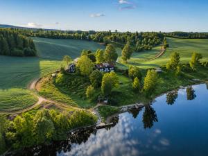 an aerial view of a house on an island in a lake at WonderInn Riverside in Årnes