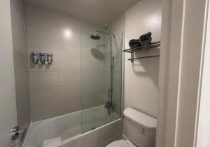 a bathroom with a tub and a toilet and a shower at Lyrios Vacation Rentals - Legacy in Kissimmee +22 photos