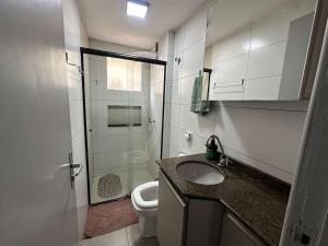 a bathroom with a toilet and a sink and a shower at Ape do lado do ginasio lago faculdades e mercados in Toledo