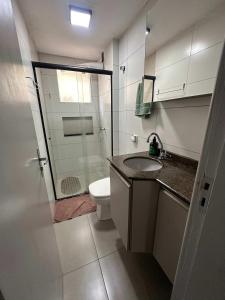 a bathroom with a toilet and a sink and a shower at Ape do lado do ginasio lago faculdades e mercados in Toledo