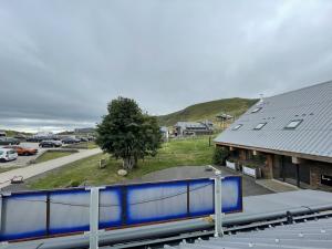 a view of a building with a train station at Appartement le bouc in Albepierre-Bredons
