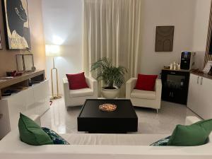 a living room with two chairs and a table at TIZIANA'S HOUSE in Salerno +68 photos