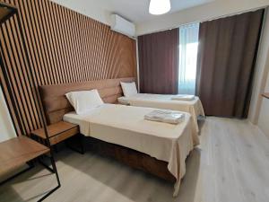 a hotel room with two beds and a chair at Moda Hotel in Kırklareli +57 photos