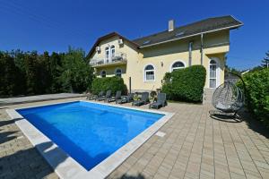 a swimming pool in front of a house at Royal Villa in Balatonfüred +84 photos