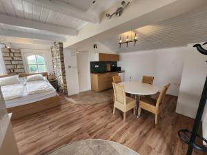 a bedroom with a bed and a table and chairs at Lake Horizon in Balatonfüred