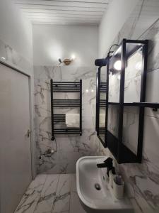 a white bathroom with a sink and a mirror at Lake Horizon in Balatonfüred +12 photos