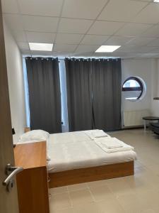 a hospital room with a bed and a window at APARTMÁN CENTRUM Palackého in Trenčín