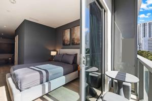 a bedroom with a bed and a balcony with a table at Vibras Wellness in Miami +95 photos