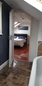 a bedroom with a bed and a tub in a room at 5 Tamar in Findon