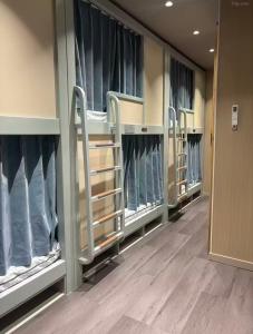 a row of bunk beds in a hospital room at Moon Homestay in Jincheng
