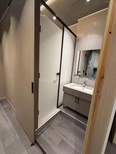 a bathroom with a sink and a mirror at Moon Homestay in Jincheng