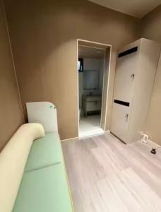 an empty room with a bed and a room with a door at Moon Homestay in Jincheng