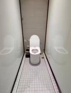 a bathroom with a toilet in a stall at Moon Homestay in Jincheng +3 photos