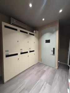 a garage with white cabinets and a door at Moon Homestay in Jincheng