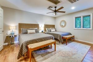 a bedroom with two beds and a ceiling fan at 4-Season Boathouse, Hot Tub! Guadalupe River Oasis in Seguin +45 photos