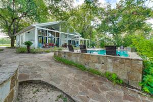 an exterior view of a house with a swimming pool at 4-Season Boathouse, Hot Tub! Guadalupe River Oasis in Seguin