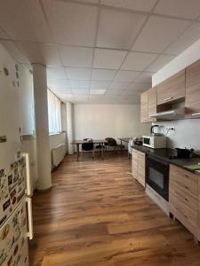 an empty room with a kitchen with a table at APARTMÁN CENTRUM Palackého in Trenčín