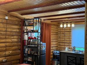 a kitchen with wooden walls and a stove and a refrigerator at Villa Shoda in Oni