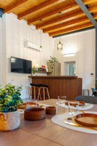 a dining room with a table and a tv at Antiche Cantine Bed & Breakfast in Alcamo