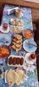 a table with many plates of food on it at Gugas cottage and guest house in Lakhiri in Lakhiri +37 photos