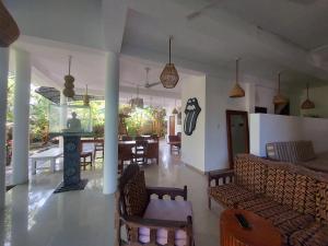 a living room with a fireplace and a dining room at Randi Guest Mirissa in Mirissa +129 photos
