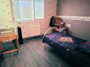 a bedroom with a bed and a wooden floor at LA BOUVIERE in Aulnat +6 photos