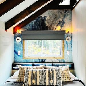 a bedroom with a window and a bed with pillows at Momentôm Refuges Nature in Petite-Rivière-Saint-François +112 photos