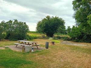 a picnic table in the middle of a field at Kamer in Fermette Vlaamse Ardennen in Maarkedal +6 photos