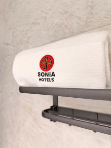 a white towel on a towel rack in a bathroom at Sonia Hotel in Accra